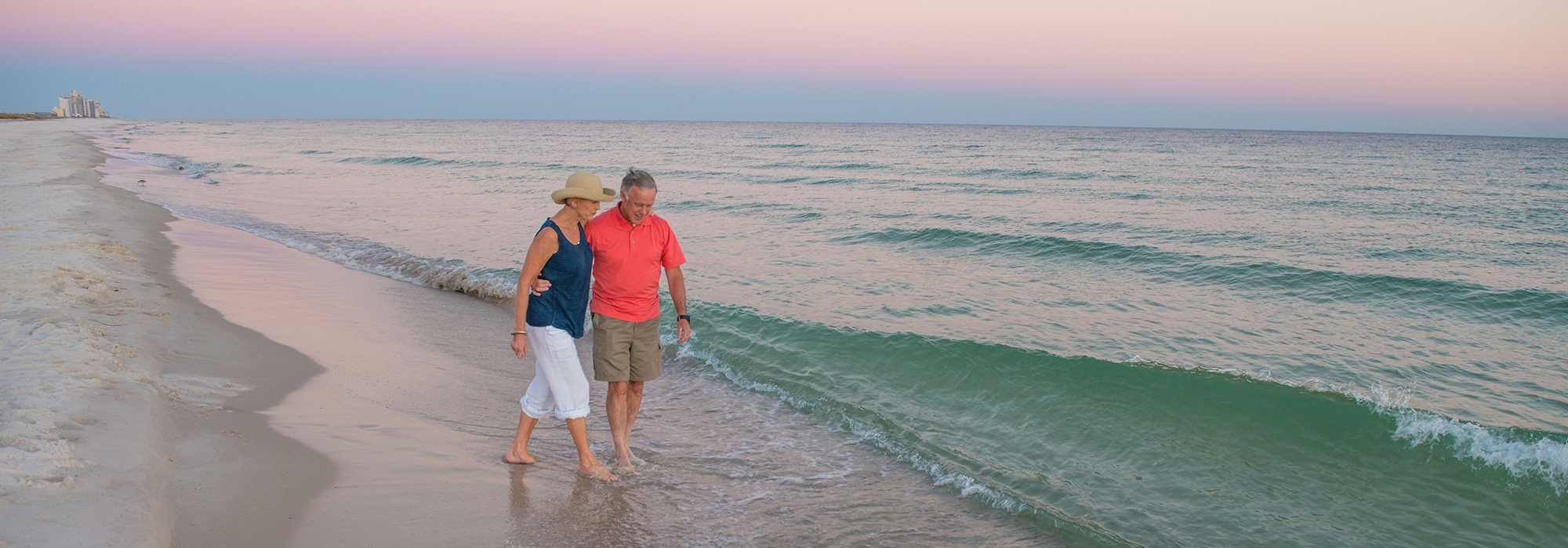 couple-walking-on-beach-at-dusk